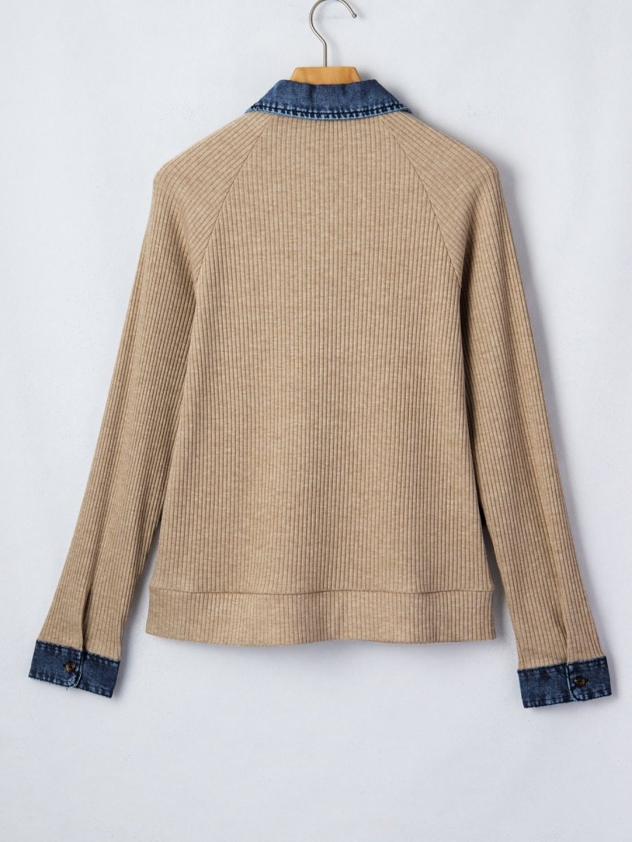 Beige ribbed sweater with blue trim on a white background