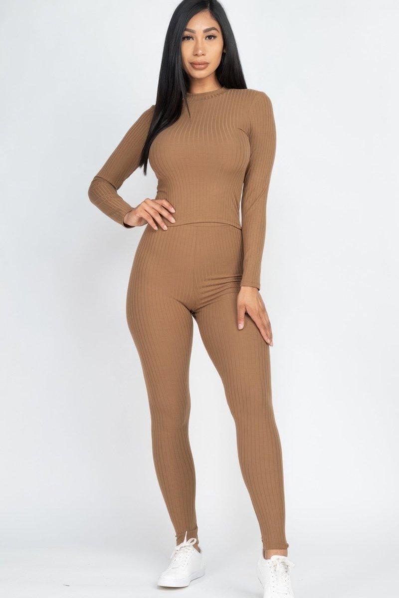 Woman wearing a brown ribbed outfit on a white background