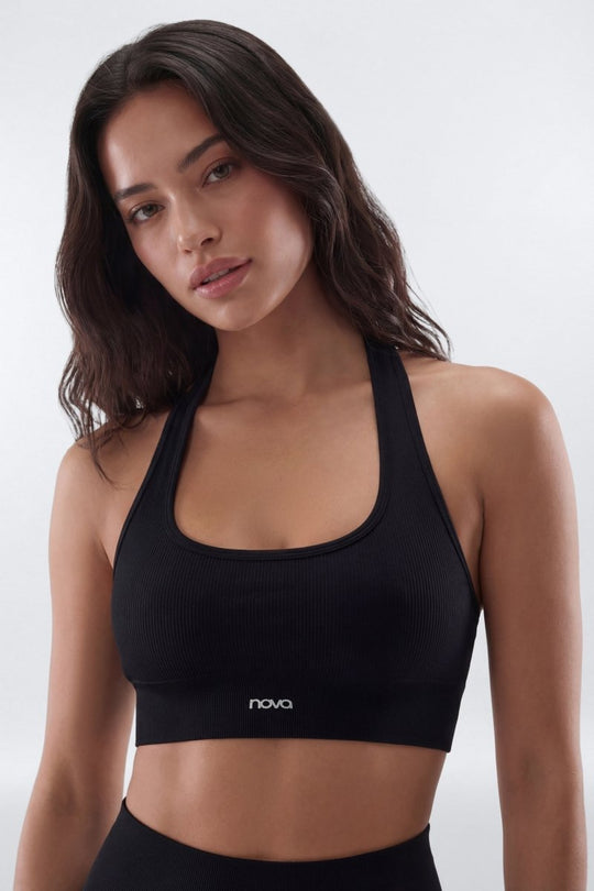 Woman wearing a black sports bra with &