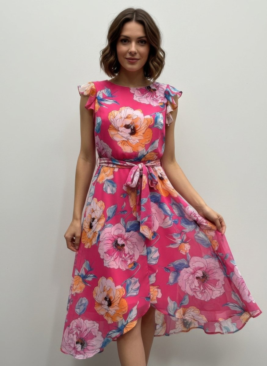 Woman wearing a pink floral dress against a plain background