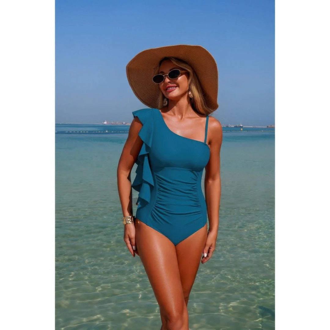 Woman in a blue swimsuit and sun hat standing in clear water with a blue sky.
