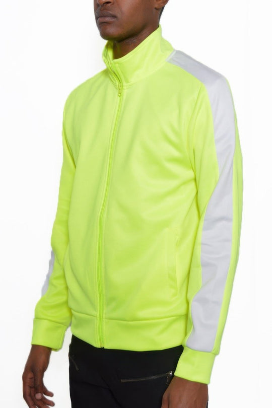 Man wearing a bright yellow tracksuit with white sleeves on a white background