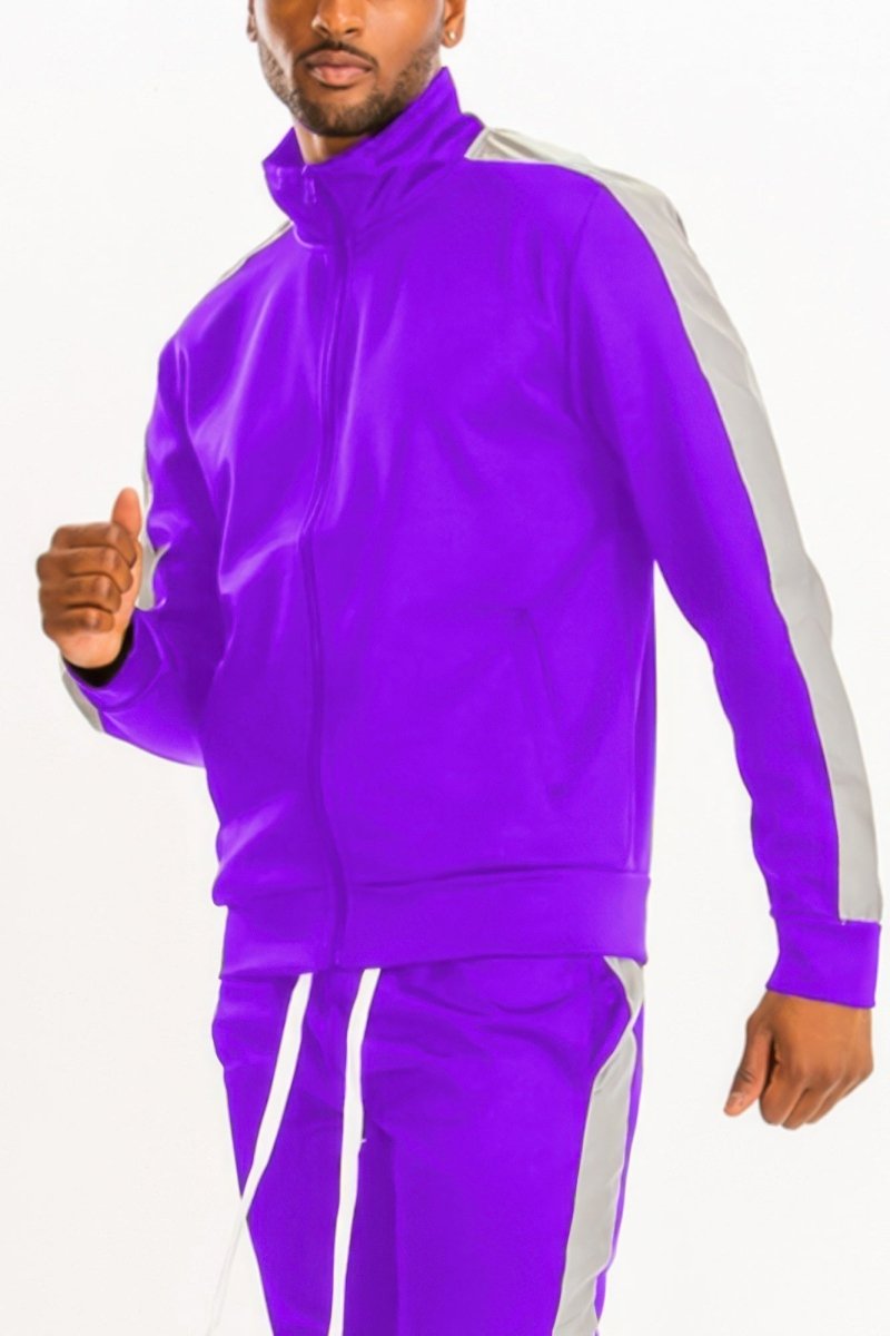 Man wearing a purple tracksuit with white stripes on a white background