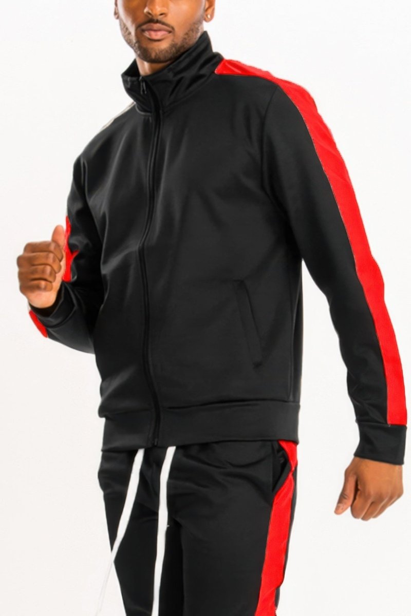 Person wearing a black and red tracksuit on a white background