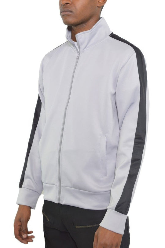 Man wearing a light gray track jacket with dark gray sleeves on a white background
