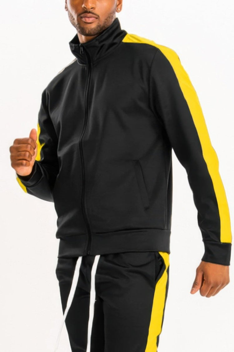 Man wearing a black and yellow tracksuit on a white background