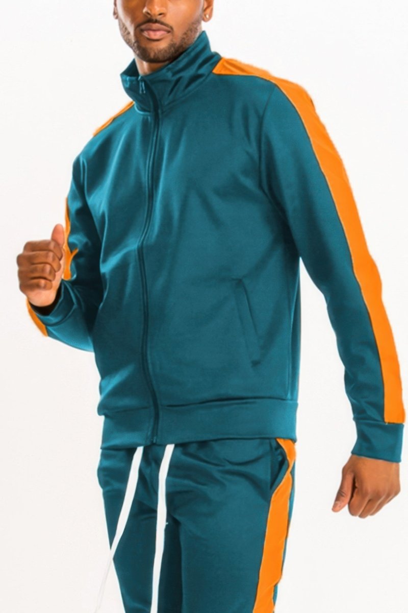 Man wearing a teal and orange tracksuit on a white background