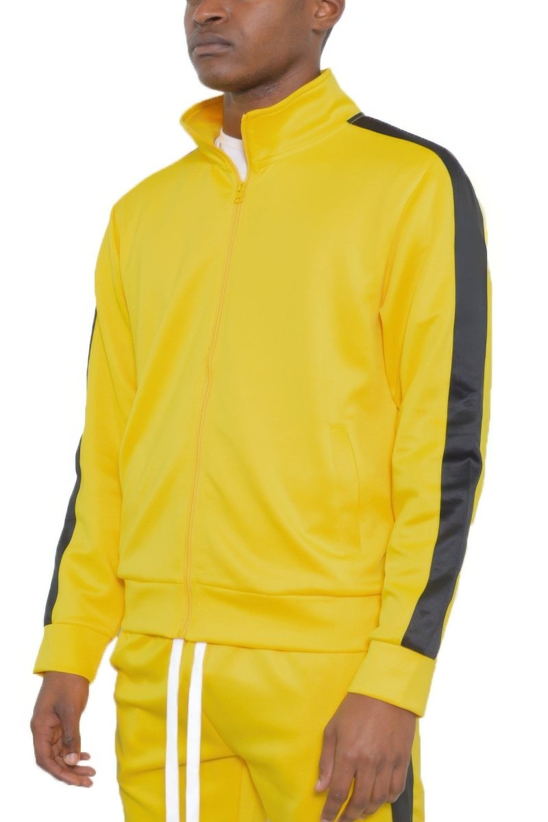 Yellow tracksuit with black sleeves worn by a person on a white background