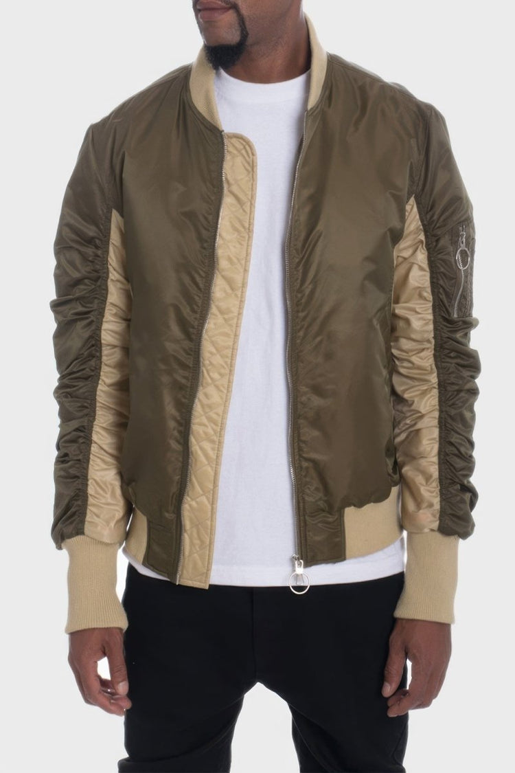 Person wearing a green and beige jacket on a white background