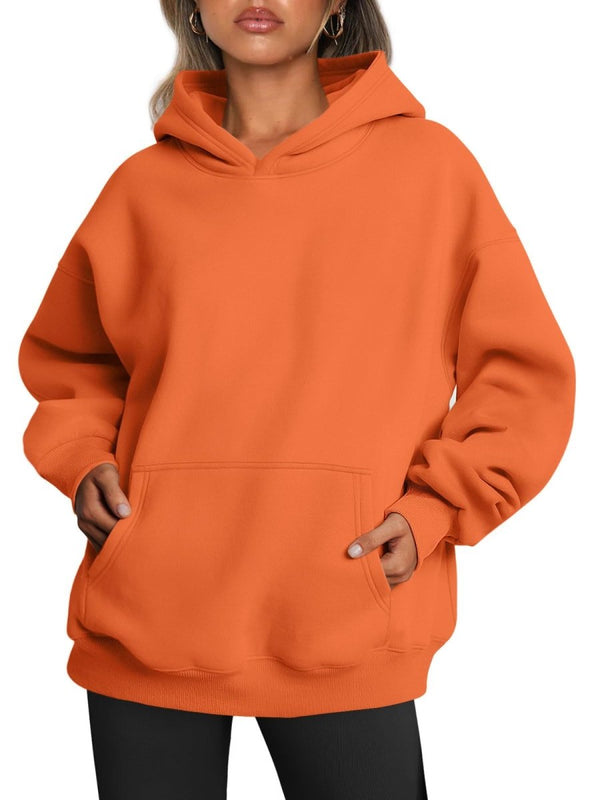Orange hoodie worn by a person on a white background