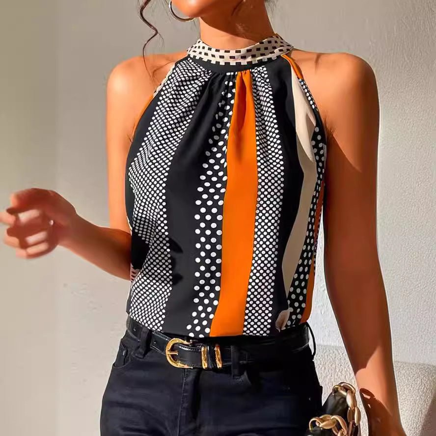 Woman wearing a sleeveless top with black, white, and orange pattern against a neutral background